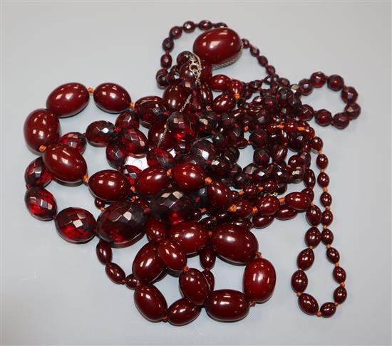 A small group of assorted simulated cherry amber necklaces including facetted.